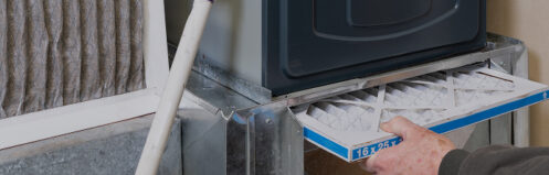 Man changing the filter in their furnace