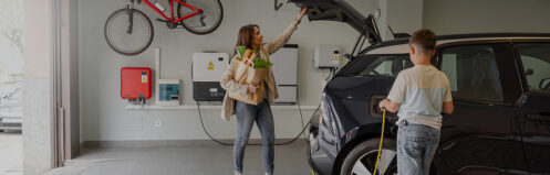 Mom shutting the trunk of her EV while charging the car
