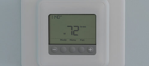 Thermostat on a wall set to 72 degrees