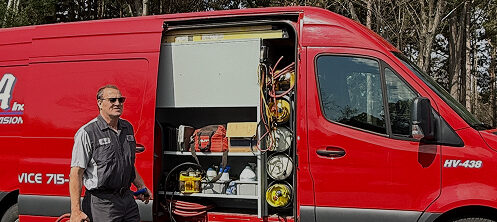 PGA Inc. technician in front of their work van